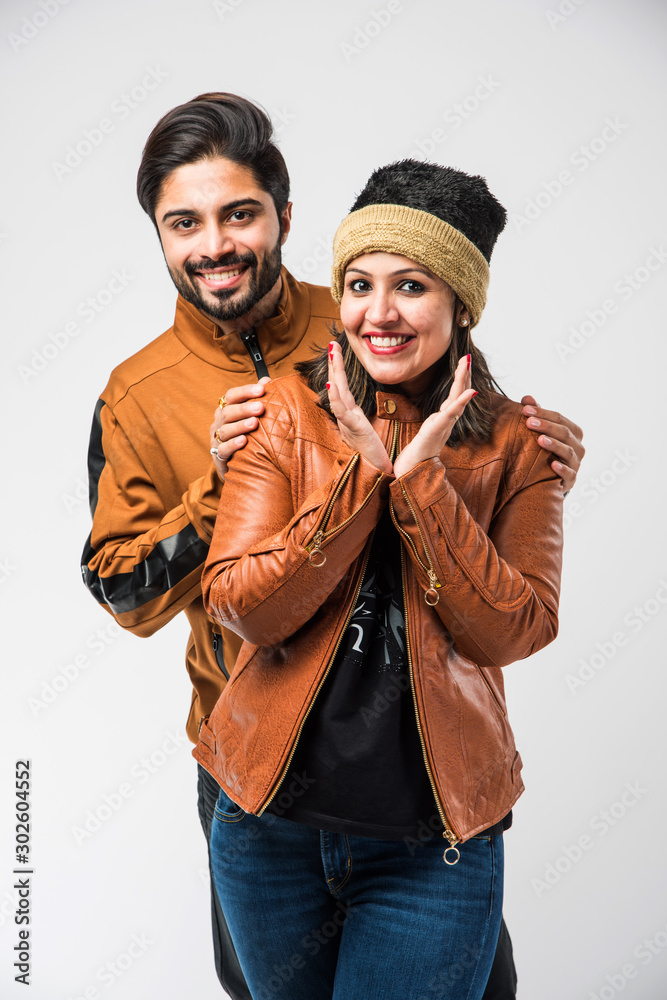 Image of Indian young couple in winter wear /warm clothes against white  background-PF005541-Picxy