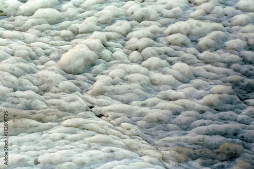 Closeup toxic foam pollutes in river