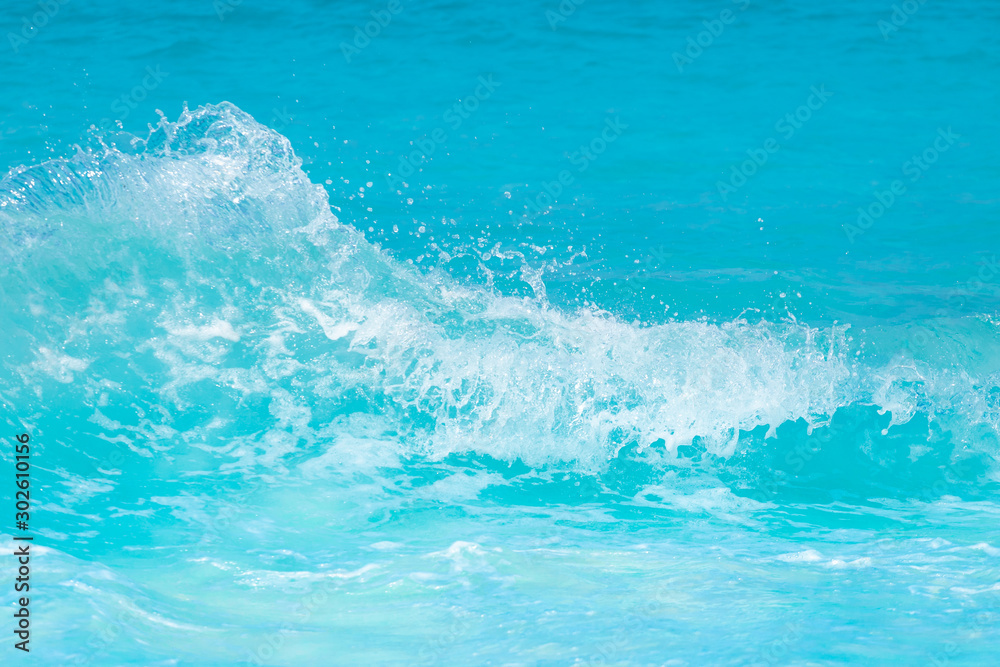 The beautiful sea wave with blue foam and turquoise color.