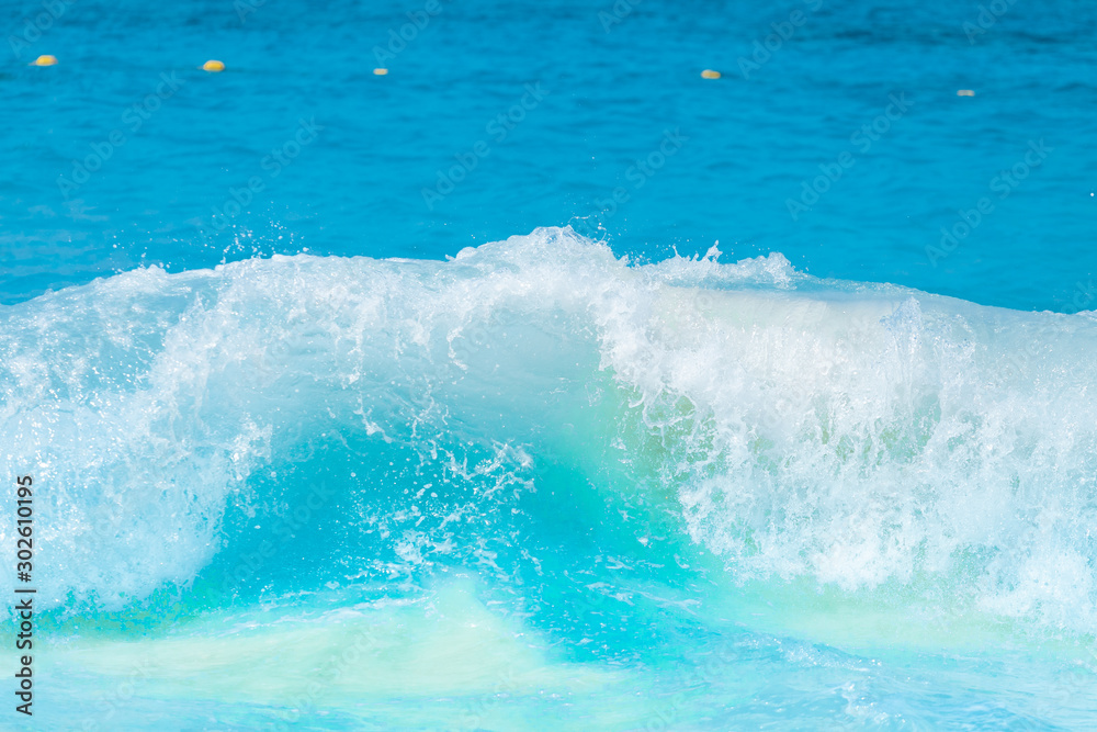 The beautiful sea wave with blue foam and turquoise color.