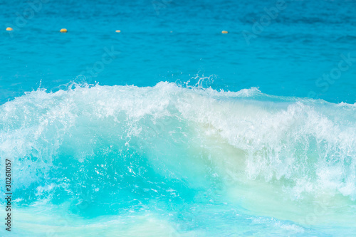 The beautiful sea wave with blue foam and turquoise color.