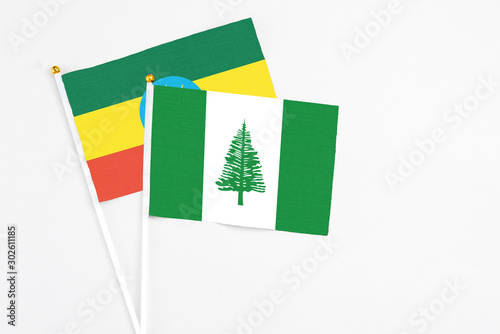 Norfolk Island and Ethiopia stick flags on white background. High quality fabric, miniature national flag. Peaceful global concept.White floor for copy space. Free Download Norfolk Island and Ethiopia stick flags on white background. High quality fabric, miniature national flag. Peaceful global concept.White floor for copy space. - GFXLoad