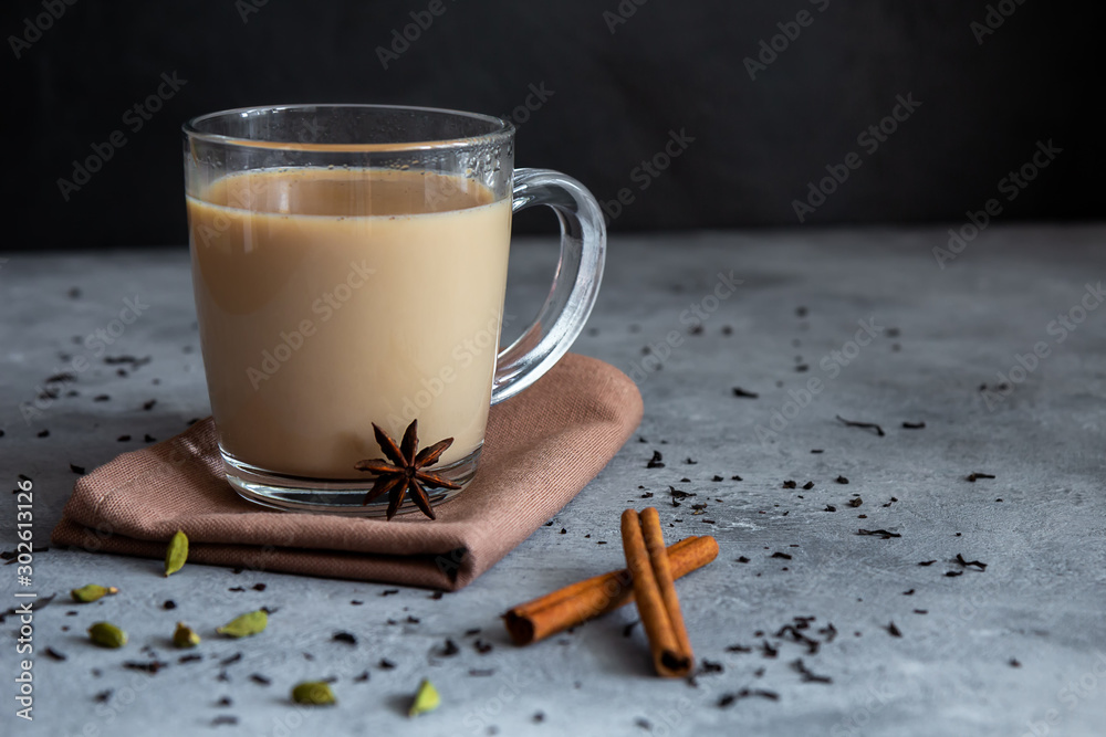 Indian tea masala chai with spices in a glass mug