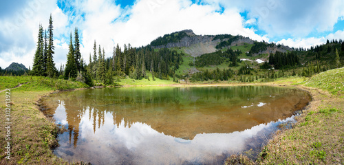 Panoramic view on mountain lake and cloud sky, Little Tipsoo Lake, Washington, United States. photo