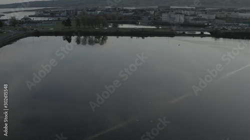 Commuters Travelling along Lakeside on Grey Irish Morning photo