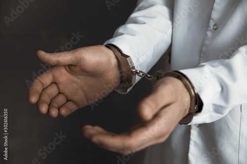 doctor hand handcuffs