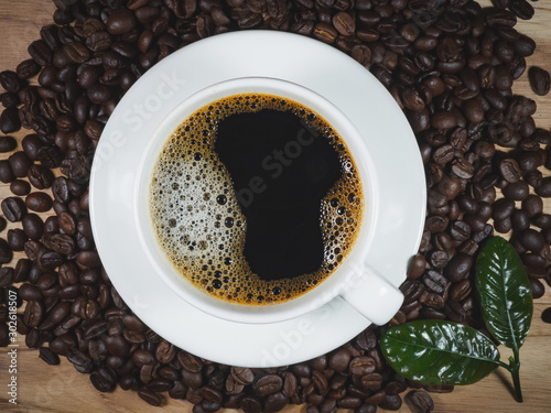 Coffee cup coffee beans coffee leaf on the table