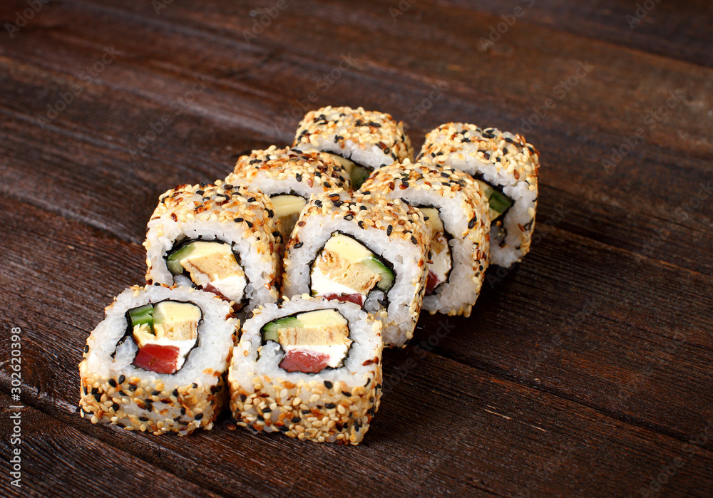 Sushi rolls on a wooden table Sushi rolls on a wooden table