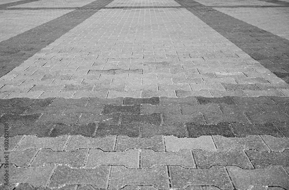 Fototapeta Perspective View Monotone Gray Brick Stone Pavement on The Ground for Street Road. Sidewalk, Driveway, Pavers, Pavement in Vintage Design Ground Flooring Square Pattern Texture Background