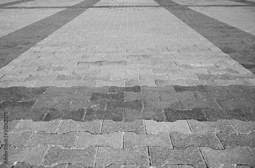 Perspective View Monotone Gray Brick Stone Pavement on The Ground for Street Road. Sidewalk, Driveway, Pavers, Pavement in Vintage Design Ground Flooring Square Pattern Texture Background