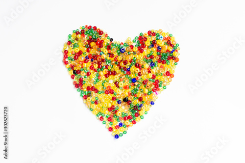 Colorful beads, heart shape space for photo or text isolated on white background. Valentine's Day