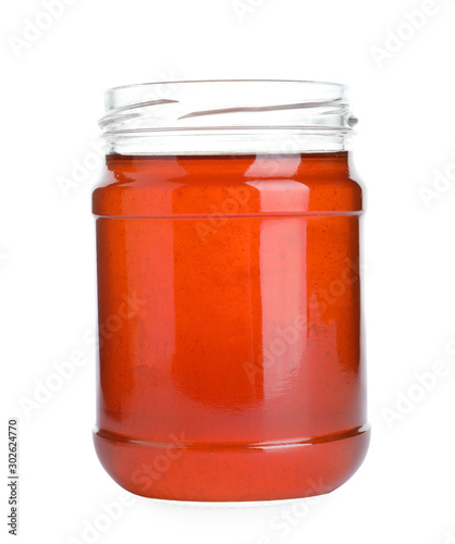 Open glass jar of wildflower honey isolated on white