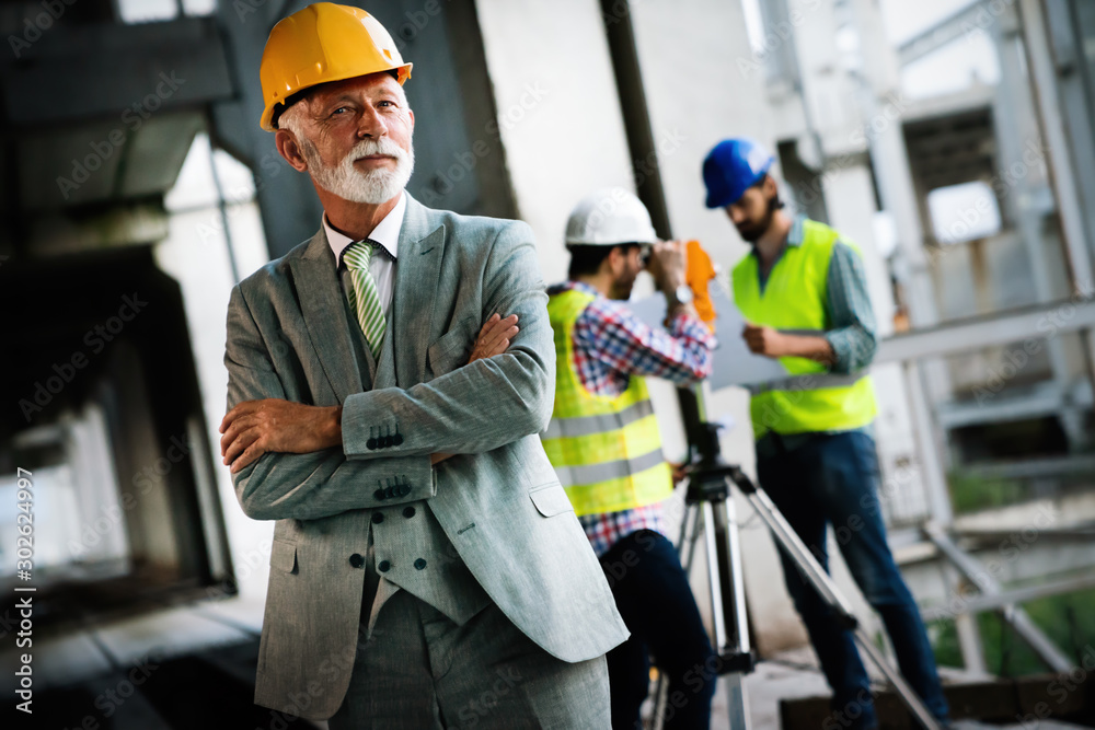Architect and construction engineer or surveyor discussion plans and blueprints Architect and construction engineer or surveyor discussion plans and blueprints