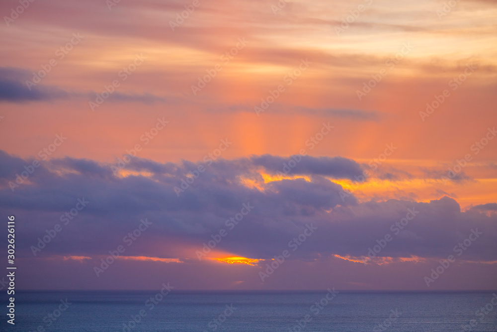 Beautiful and peaceful golden and purple sunset or sunrise over the ocean. Beautiful and peaceful golden and purple sunset or sunrise over the ocean.
