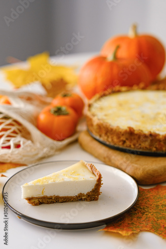 pumpkin cheesecake with persimmon. autumn concept.