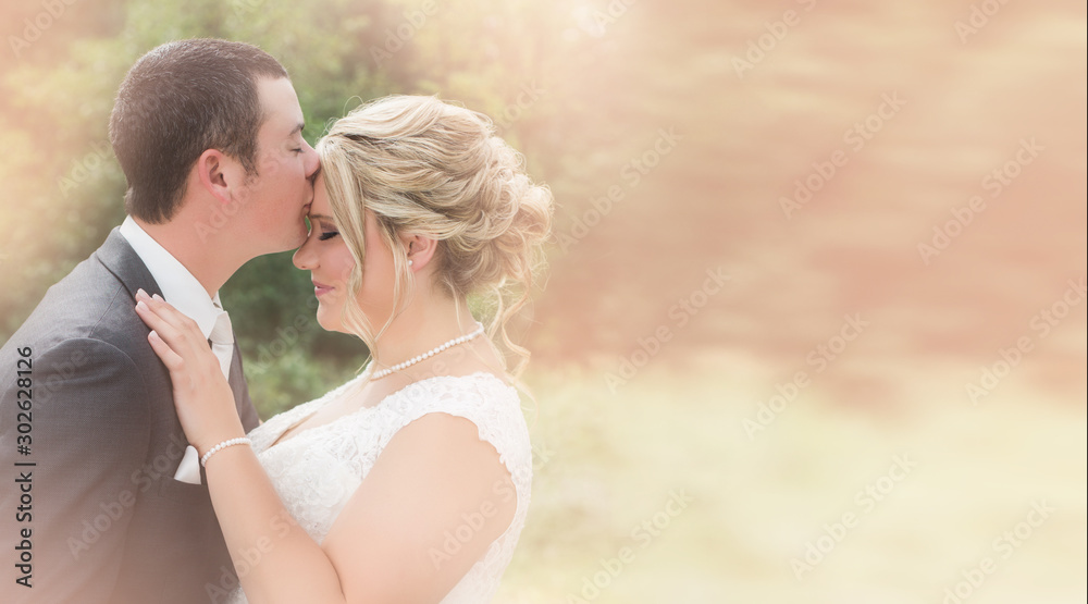 Love wedding ceremony. The bride and groom on the tree and warm background. Caucasian groom kiss bride in wedding dress. Sensual portrait of a young couple. Wedding photo outdoor. wedding copy space Love wedding ceremony. The bride and groom on the tree and warm background. Caucasian groom kiss bride in wedding dress. Sensual portrait of a young couple. Wedding photo outdoor. wedding copy space