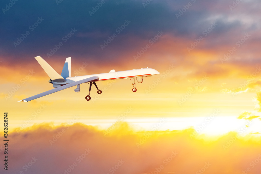 Unmanned air vehicle remote piloted aircraft drone performing in sunset cloudscape panorama.