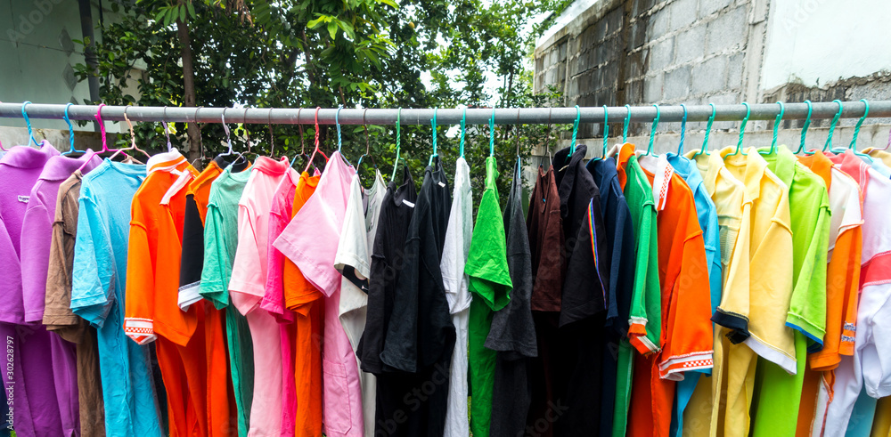 Fototapeta premium Multi colored Used Shirt with hangers.Dry clothes in hangers.