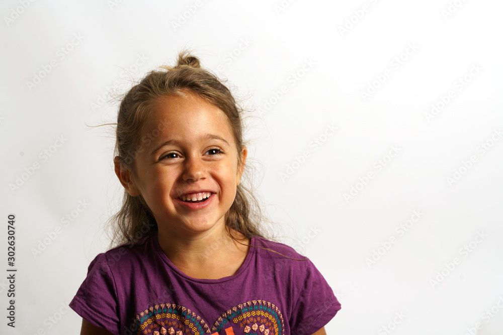 portrait on white background of a 4 year old Italian girl looking sideways portrait on white background of a 4 year old Italian girl looking sideways