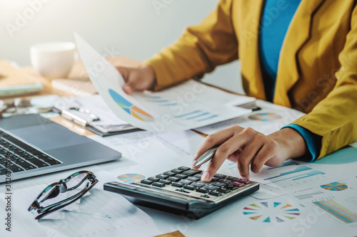 .Business woman working in finance and accounting Analyze financial budget in the office photo