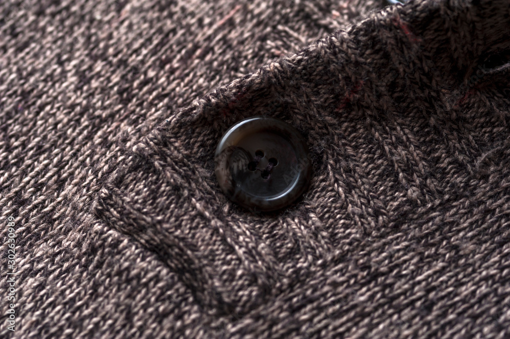 Close-up fragment of a gray knitted warm jacket Close-up fragment of a gray knitted warm jacket