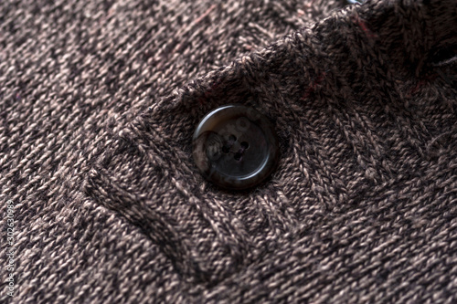 Close-up fragment of a gray knitted warm jacket