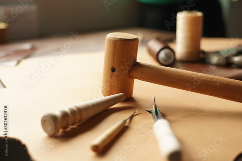 carpenter tools on wood background, leather works tool.