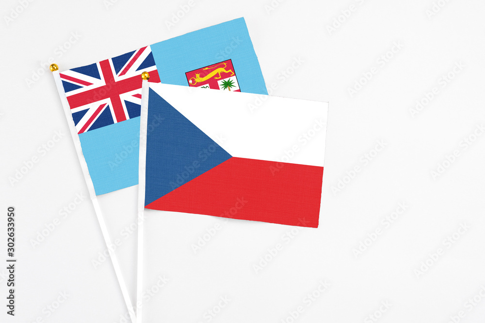 Czech Republic and Fiji stick flags on white background. High quality fabric, miniature national flag. Peaceful global concept.White floor for copy space. Czech Republic and Fiji stick flags on white background. High quality fabric, miniature national flag. Peaceful global concept.White floor for copy space.