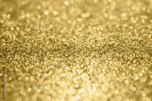 Abstract blur gold glitter sparkle defocused bokeh light background