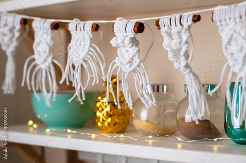 Handmade crafted macrame hanging from kitchen shelf