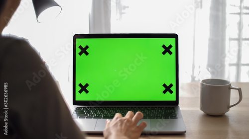 Asia woman using green screen computer at home