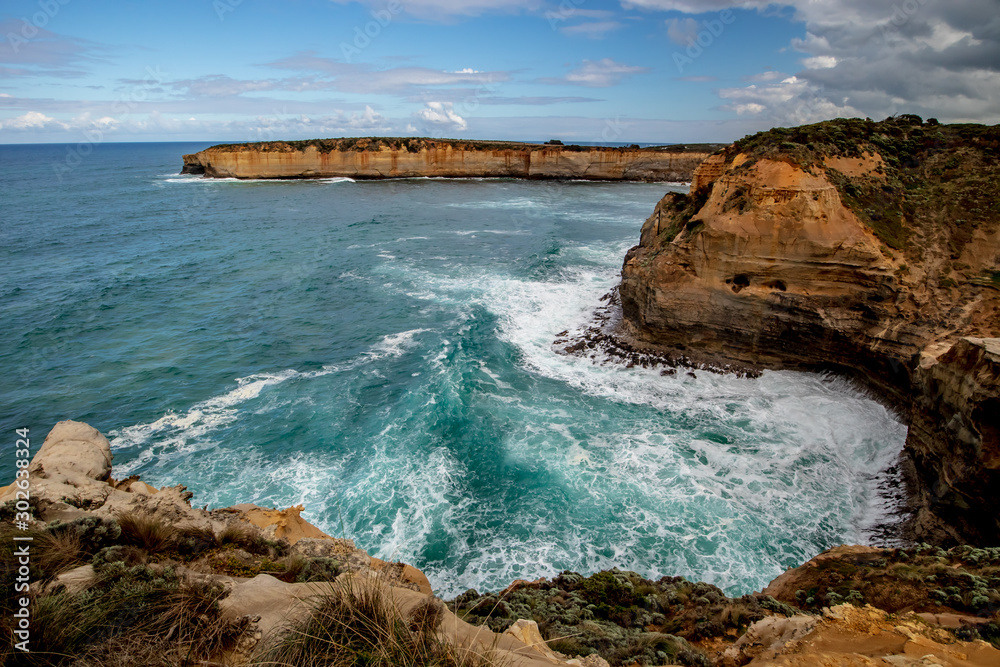 Ocean bay with strong waves. View near London Bridge. Famous stop on the Great Ocean Road. Scenic landscape. Victoria, Australia