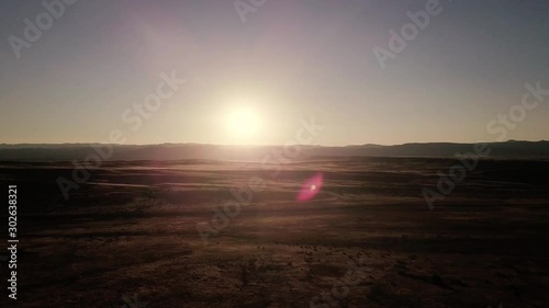 Beautiful sunset drone video footage flying away from the sun with lens flare near McInnis Canyons National Conservation Area in Colorado, United States photo