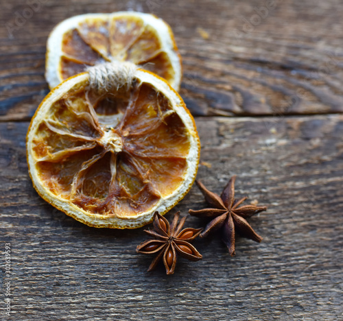dried oranges with spices on the background of wooden boards