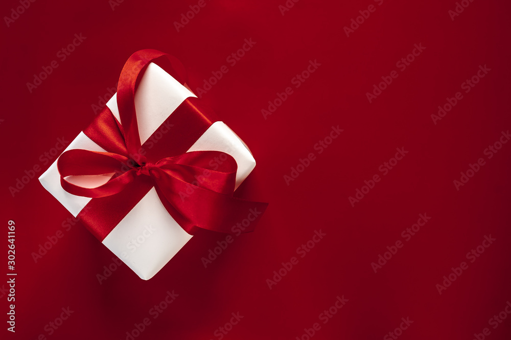 one gift box on a red background. Top view with copy space. one gift box on a red background. Top view with copy space.