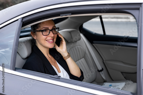 Beautiful businesswoman is driving in the car