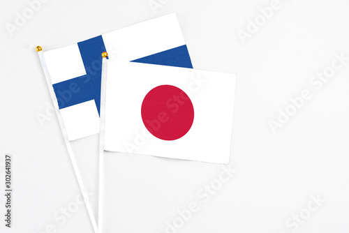Free Download Japan and Finland stick flags on white background. High quality fabric, miniature national flag. Peaceful global concept.White floor for copy space. - GFXLoad