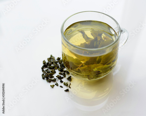 Green tea is brewed in a cup.