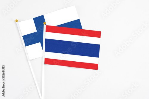 Free Download Thailand and Finland stick flags on white background. High quality fabric, miniature national flag. Peaceful global concept.White floor for copy space. - GFXLoad