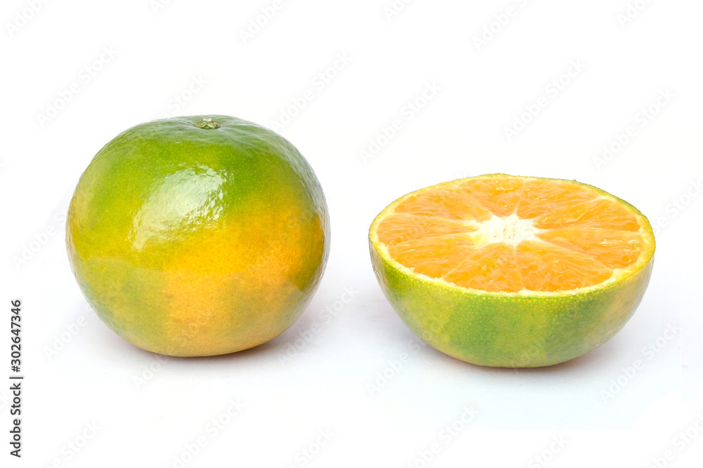 Green oranges and sliced isolated on a white Green oranges and sliced isolated on a white