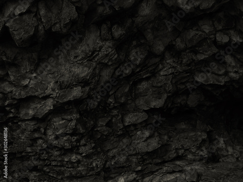Black abstract stone background. Dark rock texture. Black grunge background. Mountain close-up.