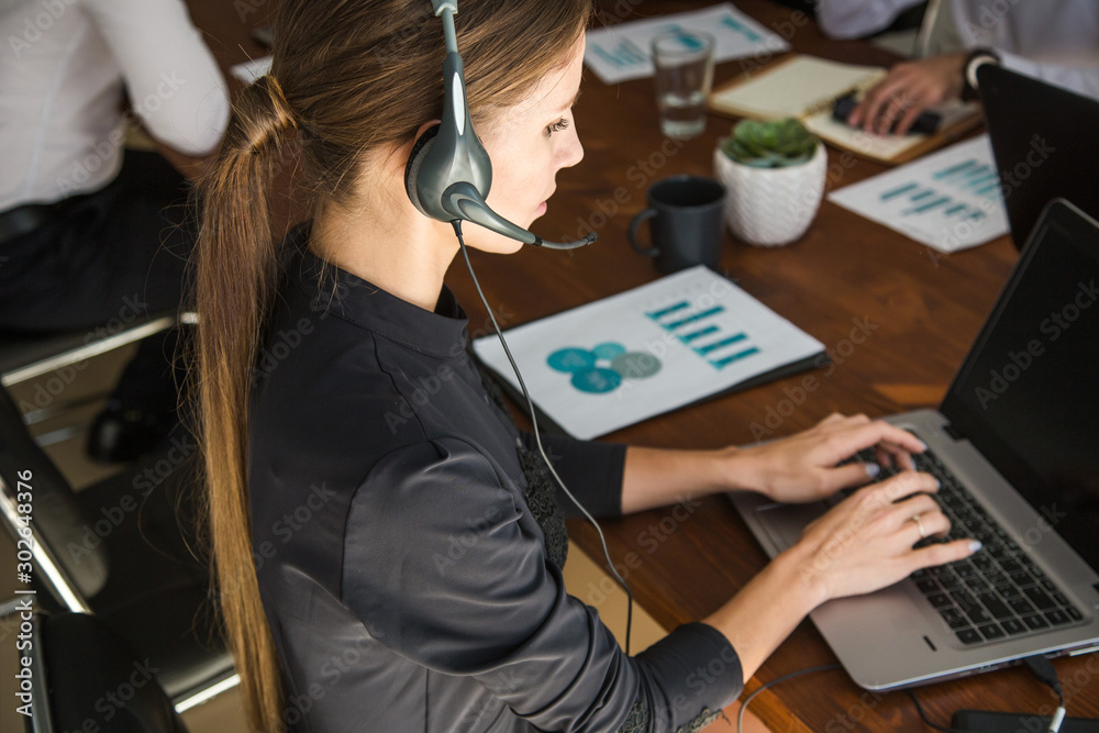 Portrait of woman customer service worker, call center smiling operator with phone on office Portrait of woman customer service worker, call center smiling operator with phone on office