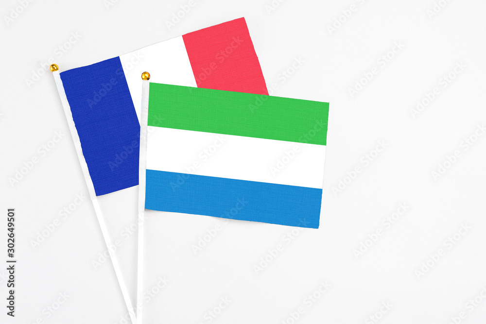 Sierra Leone and France stick flags on white background. High quality fabric, miniature national flag. Peaceful global concept.White floor for copy space. Sierra Leone and France stick flags on white background. High quality fabric, miniature national flag. Peaceful global concept.White floor for copy space.