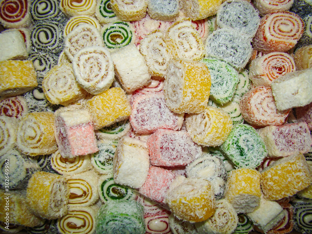 Fototapeta premium Sweet rolls for the background. Coconut Chips . Multicolor.