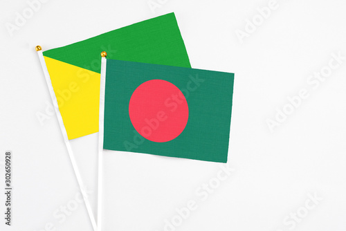 Bangladesh and French Guiana stick flags on white background. High quality fabric, miniature national flag. Peaceful global concept.White floor for copy space. Free Download Bangladesh and French Guiana stick flags on white background. High quality fabric, miniature national flag. Peaceful global concept.White floor for copy space. - GFXLoad