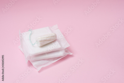 Menstrual tampon and pads on a pink background. Menstruation time. Hygiene and protection. copy space