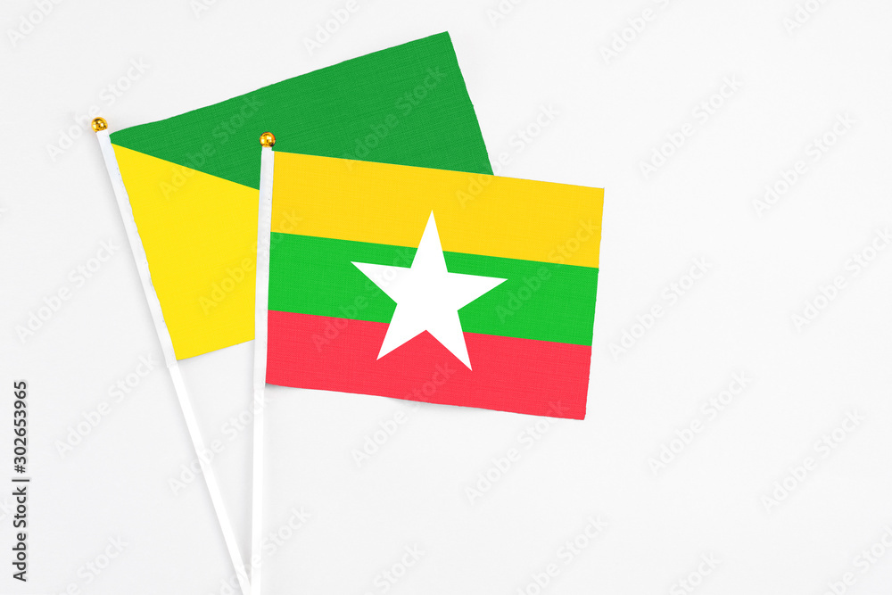Myanmar and French Guiana stick flags on white background. High quality fabric, miniature national flag. Peaceful global concept.White floor for copy space.