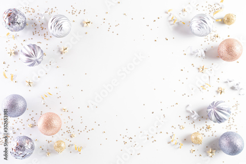 Christmas background concept. Top view of Christmas decoration, light golden and orange pastel  ball, star with snowflakes on white background.