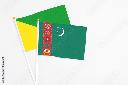 Free Download Turkmenistan and French Guiana stick flags on white background. High quality fabric, miniature national flag. Peaceful global concept.White floor for copy space. - GFXLoad