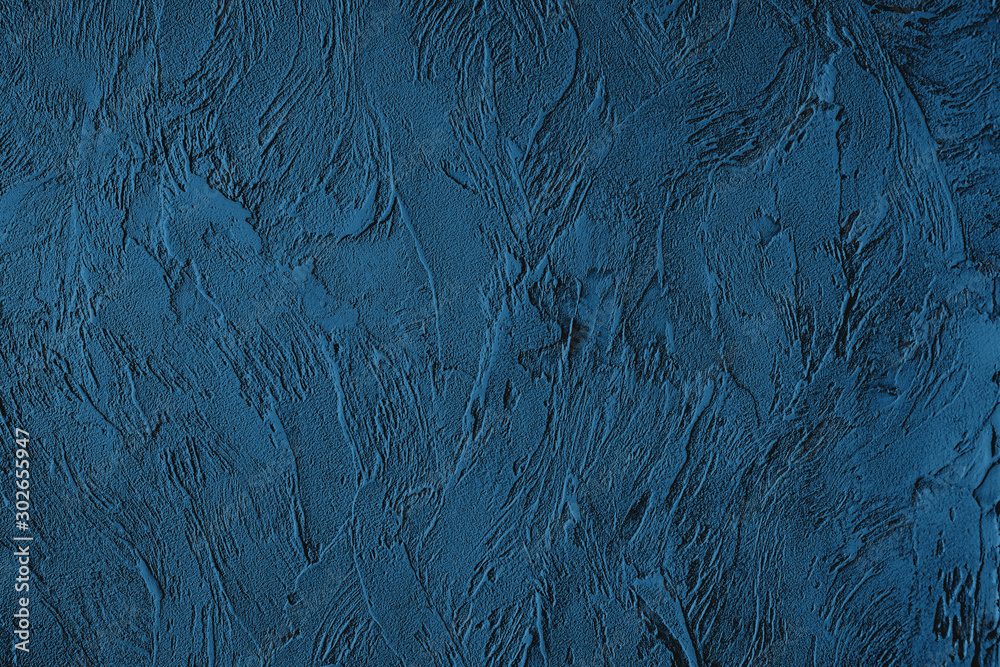 Dark blue colored low contrast Concrete textured background with roughness and irregularities to your design or product. Color trend concept.